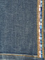 Узкие джинсы из потертого денима, декорированные кристаллами Marina Sport  –  Деталь2