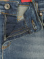 Узкие джинсы из потертого денима, декорированные кристаллами Marina Sport  –  Деталь